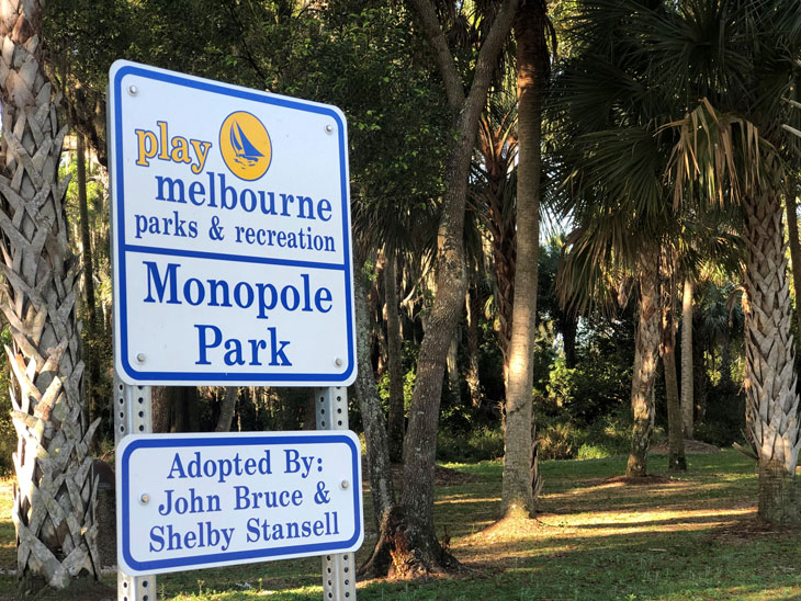 Monopole Park sign with trees in the background