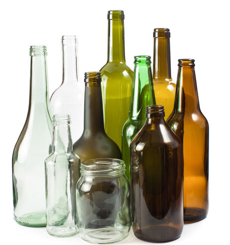 An assortment of clear, green and brown glass bottles, empty