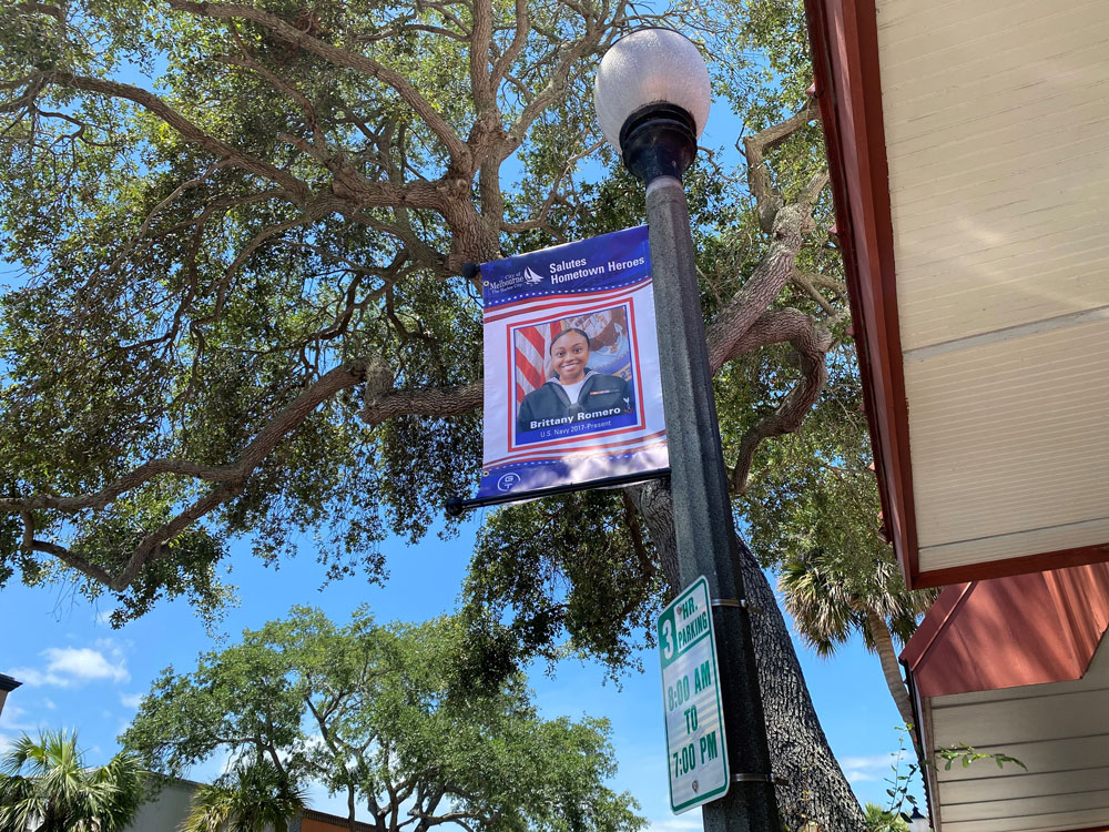 Close up of a street pole with Hometown Heroes banner featuring Brittany Romero