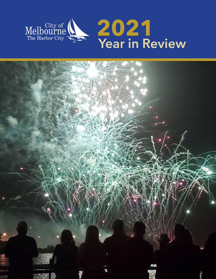 Image of City of Melbourne 2021 Year in Review report cover that feature a photo of spectators watching fireworks