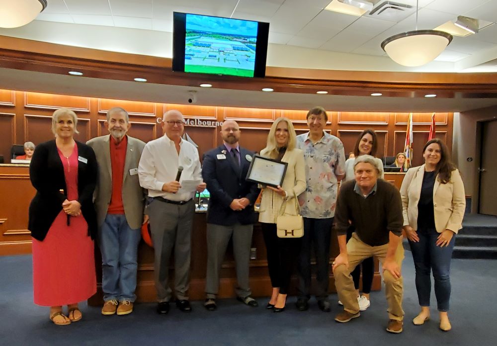 Group photo of award presentation in the City Council chamber.