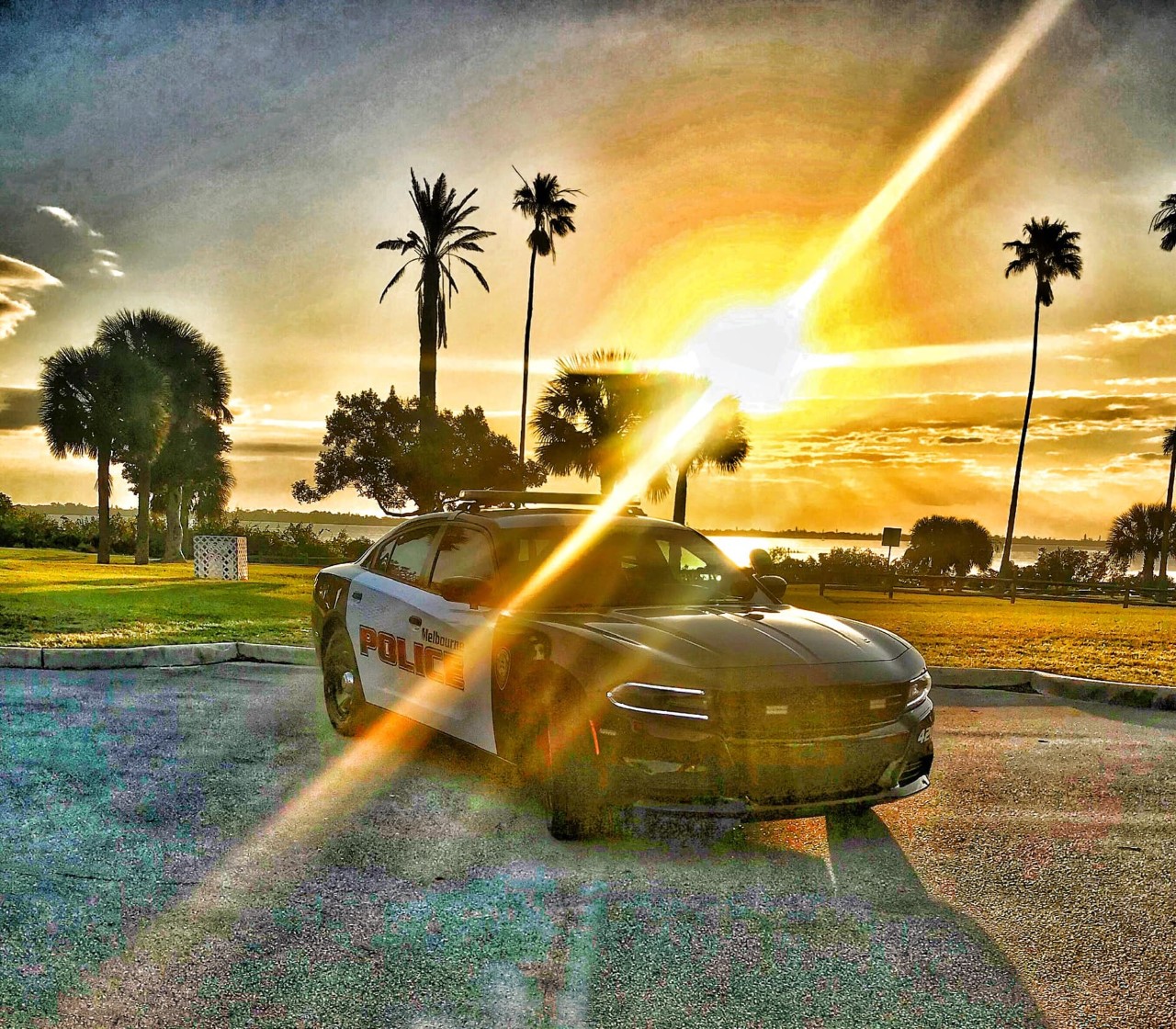 Melbourne Police patrol car with sun behind it.