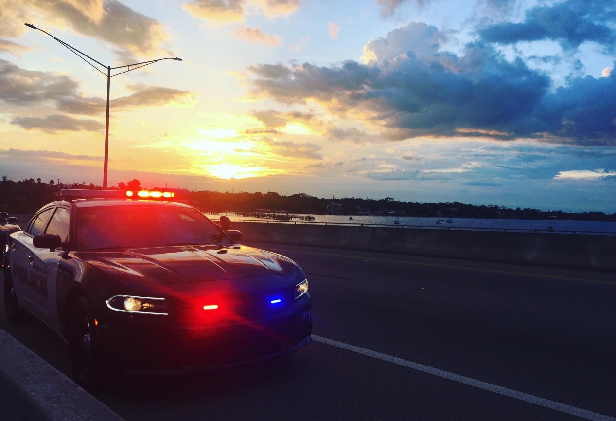 Melbourne Police patrol car parked on causeway with sunset in the background