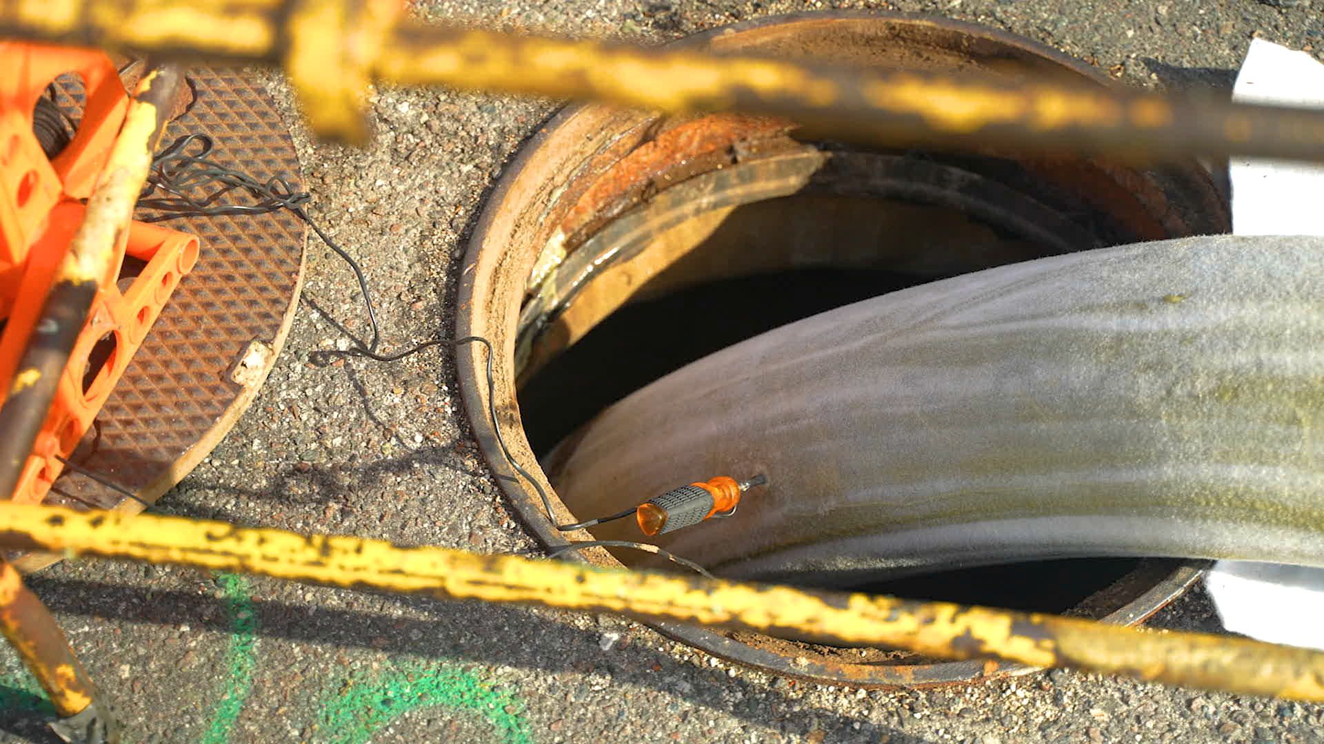 Pipe lining material going into a manhole.