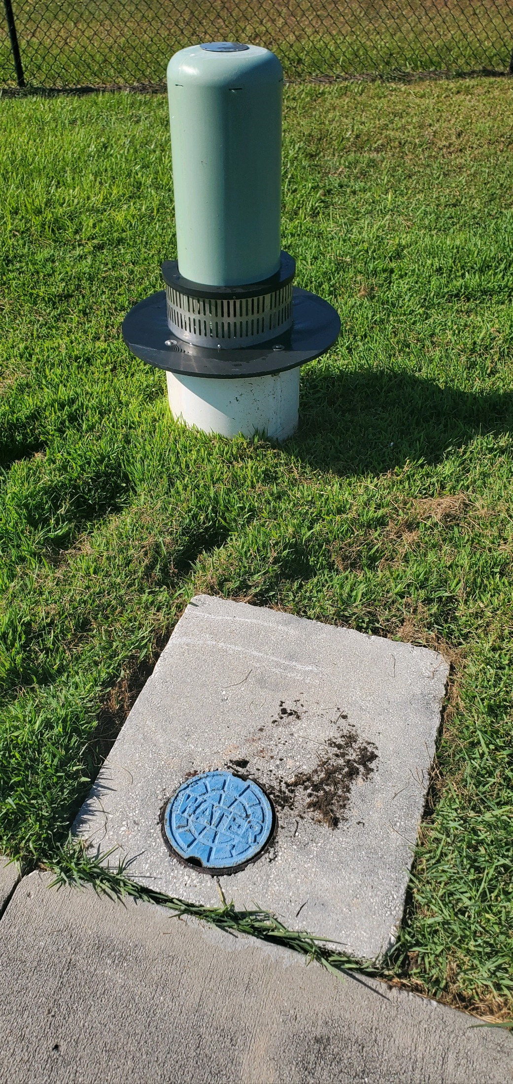 Automatic Flushing Valve next to a sidewalk