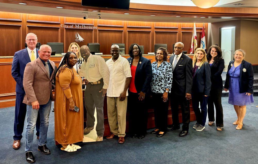 Council members, Silas Scott, his wife, Pastor and Mrs. Harris, and the city manager at the Service Award presentation in the Council Chamber.