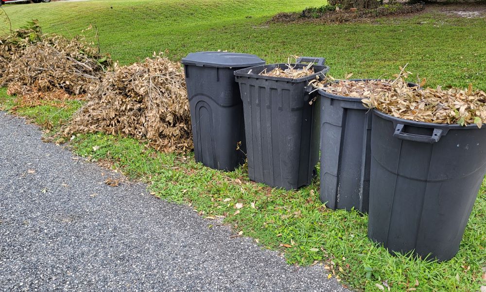 leaves and branches in containers and stacked properly for pickup in the right of way