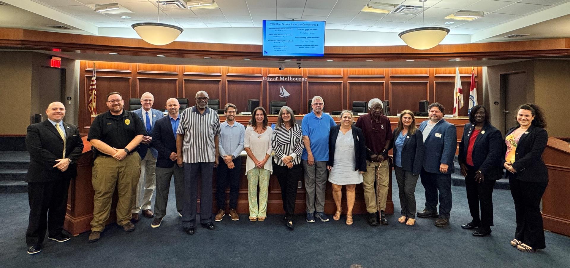 Council members, City Attorney, City Manager and volunteer board members in the Council Chamber.