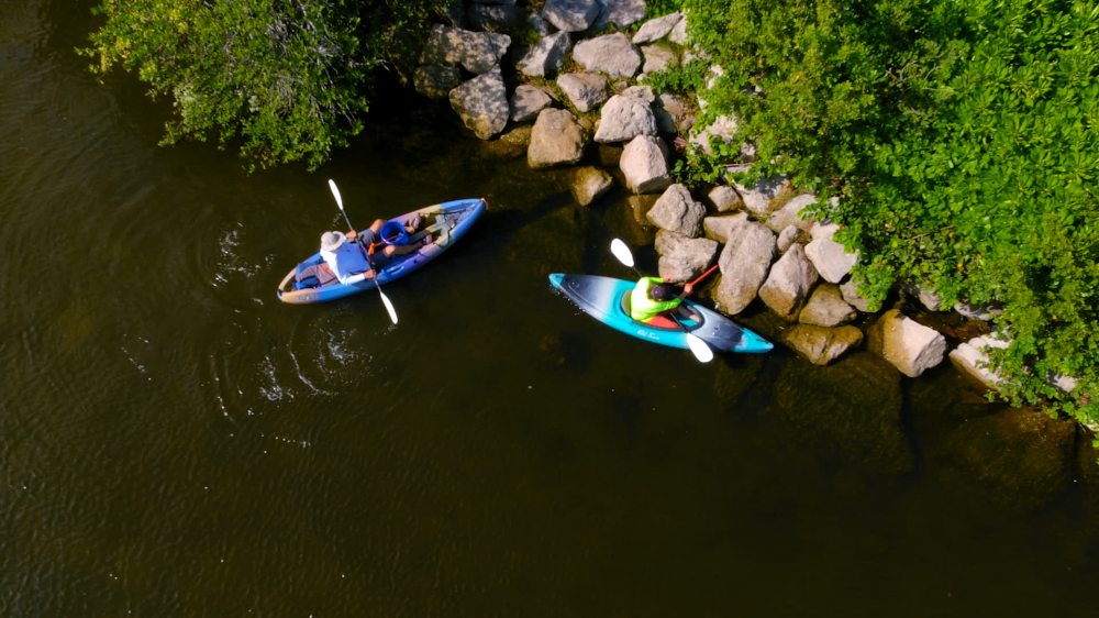 Kayakers pull trash out of rock seawall at Ballard Park