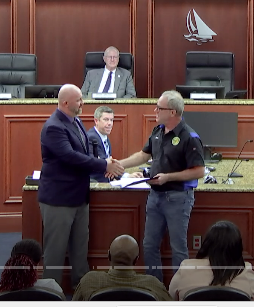 Mayor Alfrey shakes hands with Jim Conner after presenting the Exceptional Citizen Award to him in the Council Chamber.